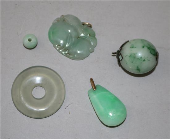 A group of four Chinese jadeite pendants or beads and a similar hardstone disc, late 19th/20th century, largest 3.3cm